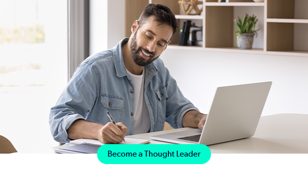 Man writing on laptop contributing to the Puppet thought leadership